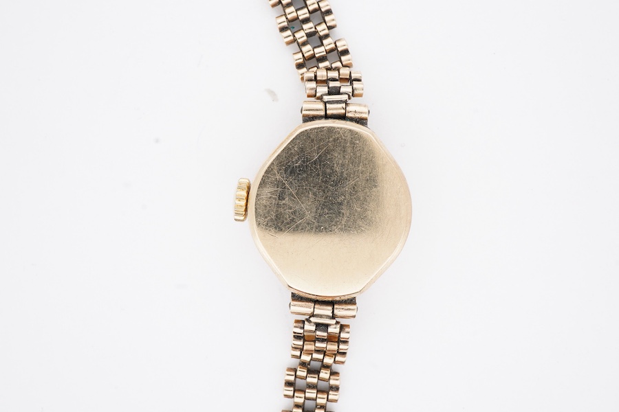 A lady's 1970's 9ct gold Rotary manual wind wrist watch, with Arabic dial, on a 9ct gold bracelet, case diameter 19mm, overall length 18cm, gross weight 15.4 grams.